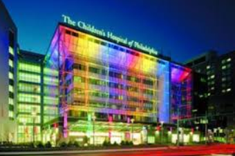 photo of the Children's Hospital of Philadelphia at night, lit up with rainbow colors
