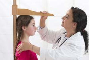 image of a doctor measuring the height of a pediatric patient