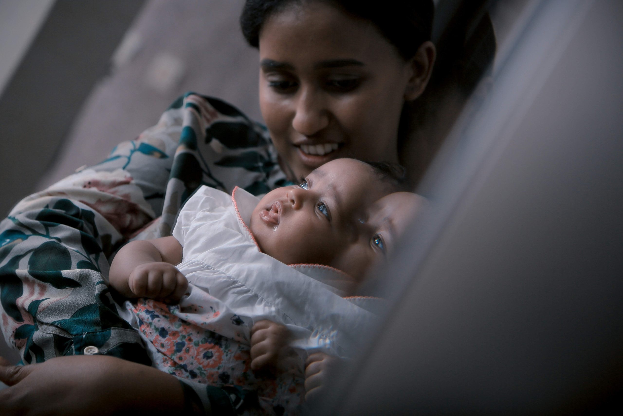A mother holding her baby.